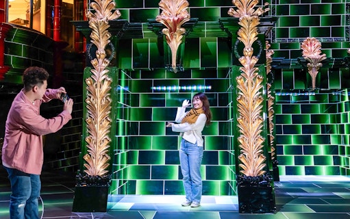 Visitors photographing in the Ministry of Magic at Warner Bros. Studio Tour Tokyo.