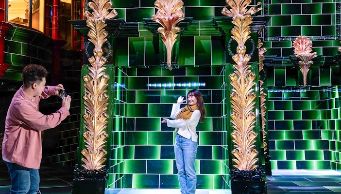 Visitors photographing in the Ministry of Magic at Warner Bros. Studio Tour Tokyo.