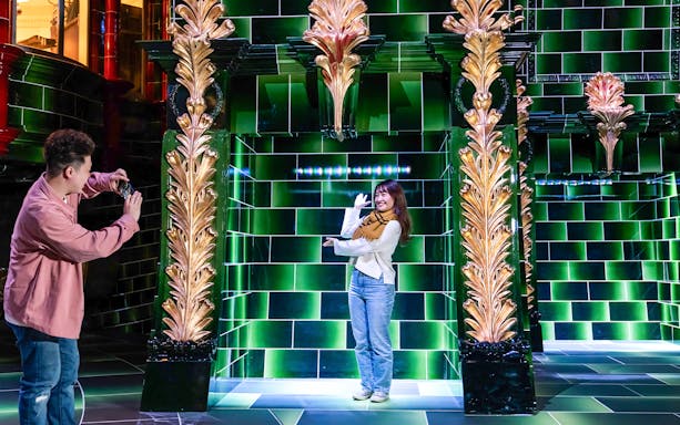 Visitors photographing in the Ministry of Magic at Warner Bros. Studio Tour Tokyo.