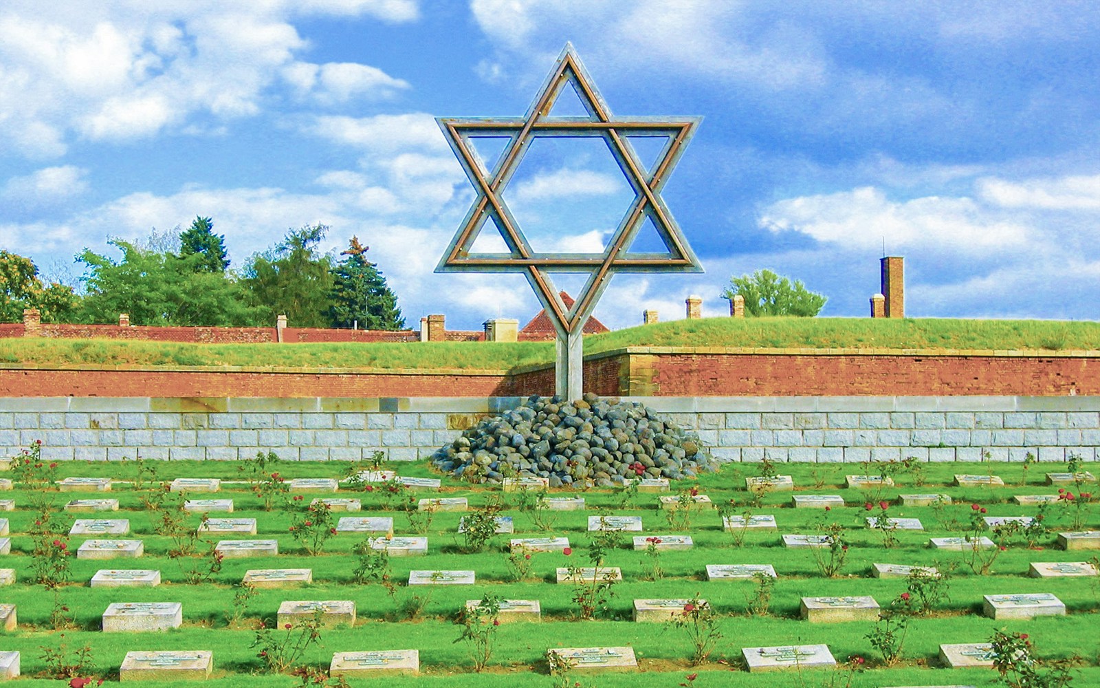 Terezin Cemetery with Star of David memorial and gravestones.