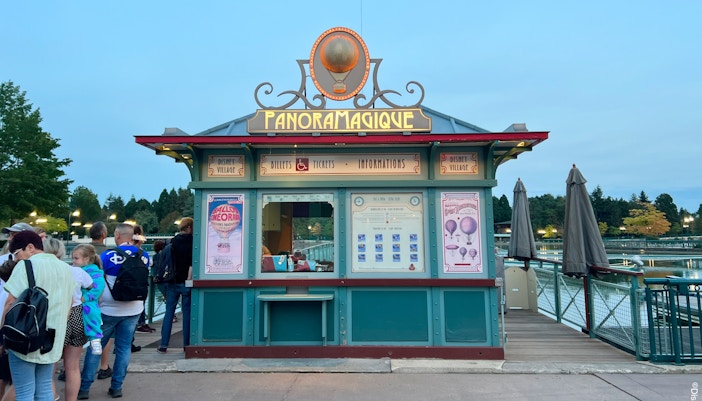 Disney Village entrance at Disneyland Paris with colorful shops and lively atmosphere.