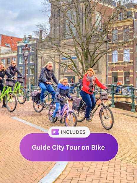 Cyclists on a guided tour crossing an Amsterdam canal bridge.