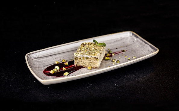 White chocolate lemon-pistachio sponge cake on Budapest Dinner Cruise plate.