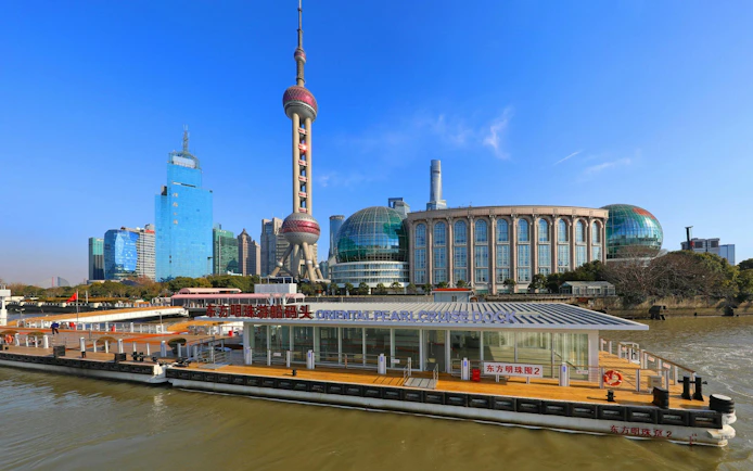 Cruise dock at Oriental Pearl Tower with Shanghai skyline in the background.