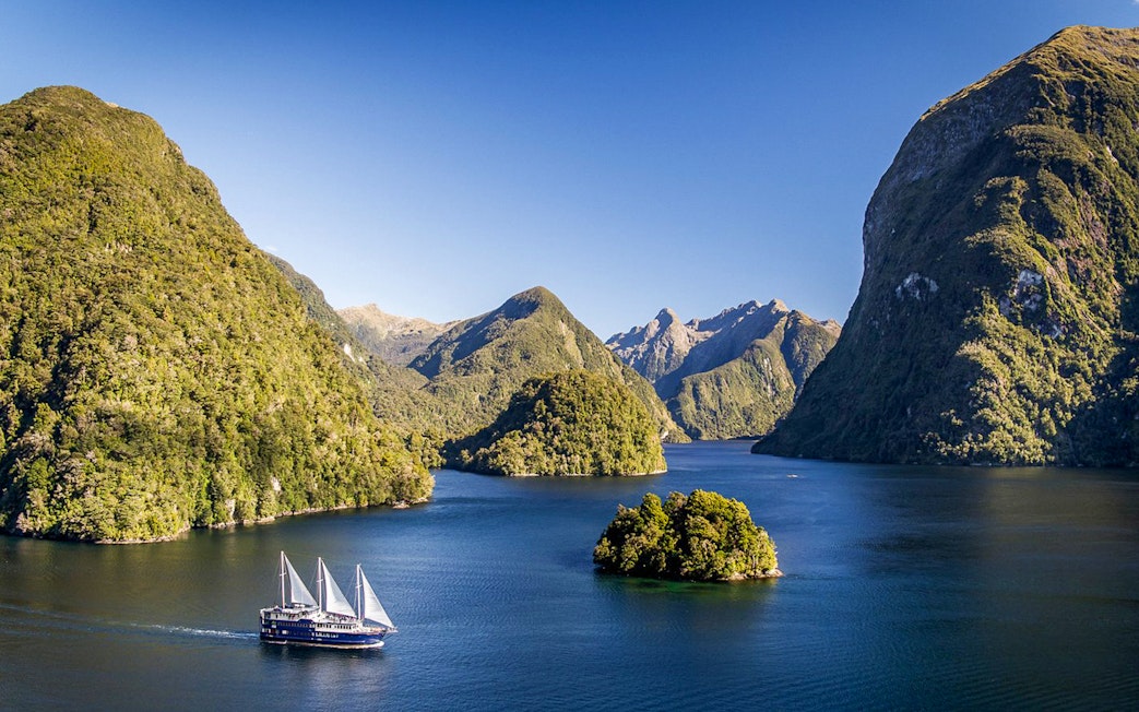 Cruise ship on overnight tour in Doubtful Sound fjord, view from Manapouri.