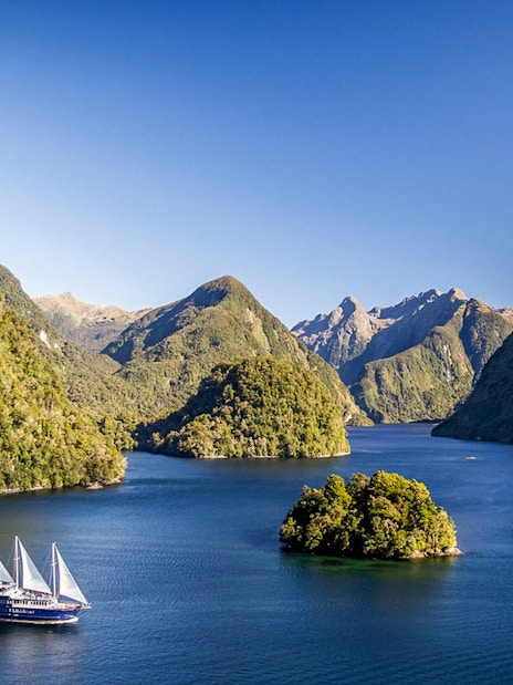 Cruise ship on overnight tour in Doubtful Sound fjord, view from Manapouri.