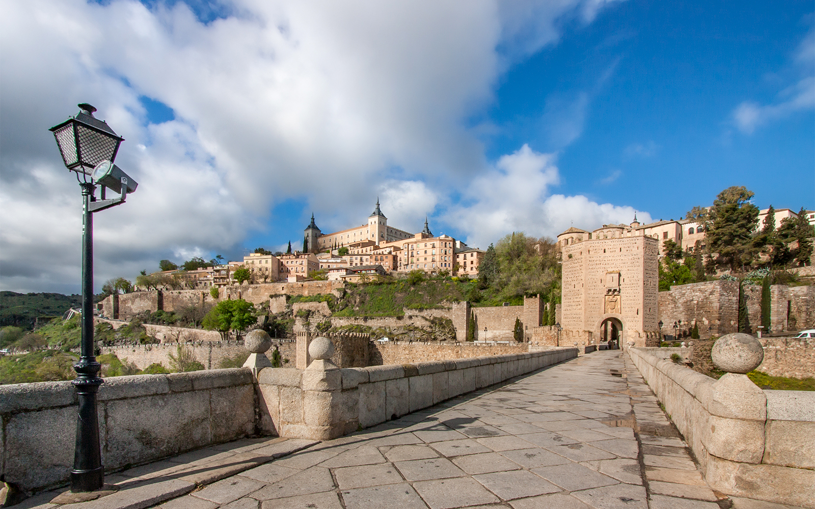 Puente de Toledo bridge over Manzanares River in Madrid, Spain, with sightseeing bus.