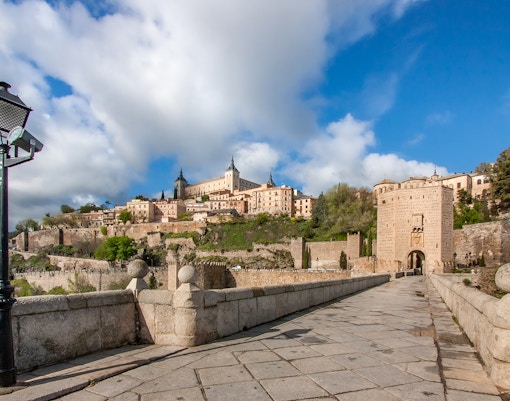 Puente de Toledo bridge over Manzanares River in Madrid, Spain, with sightseeing bus.