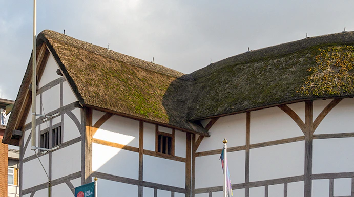Shakespeare's Globe Theatre exterior with thatched roof in London.