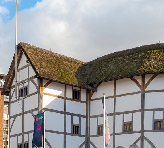 Shakespeare's Globe Theatre exterior with thatched roof in London.