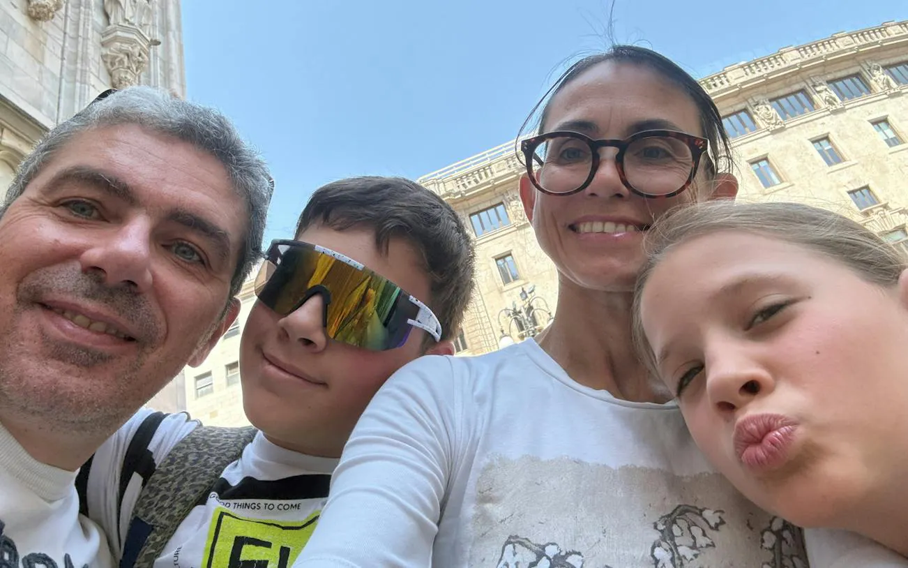 Family enjoying a self-guided city exploration game in Milan during Christmas.