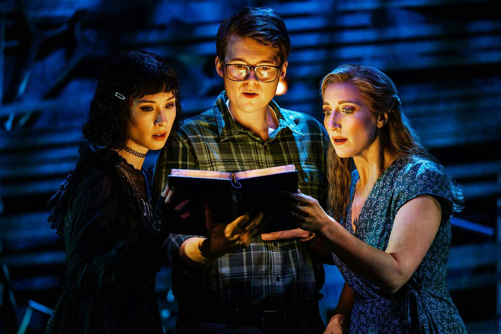 Actors reading a book during Beetlejuice stage performance in Brisbane.