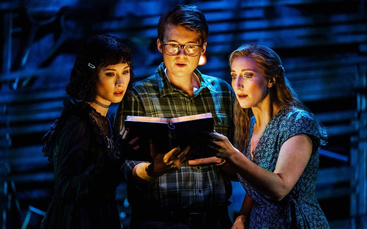 Actors reading a book during Beetlejuice stage performance in Brisbane.