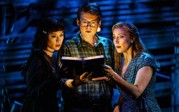 Actors reading a book during Beetlejuice stage performance in Brisbane.