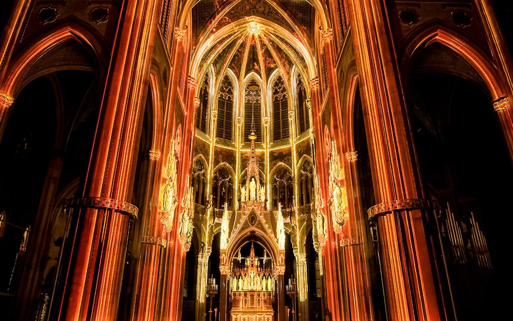 Votivkirche interior illuminated during Light of Creation event in Vienna.