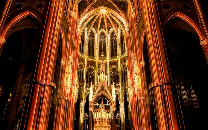 Votivkirche interior illuminated during Light of Creation event in Vienna.
