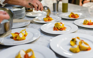 Freshly made fettuccine being plated at a Rome cooking class.