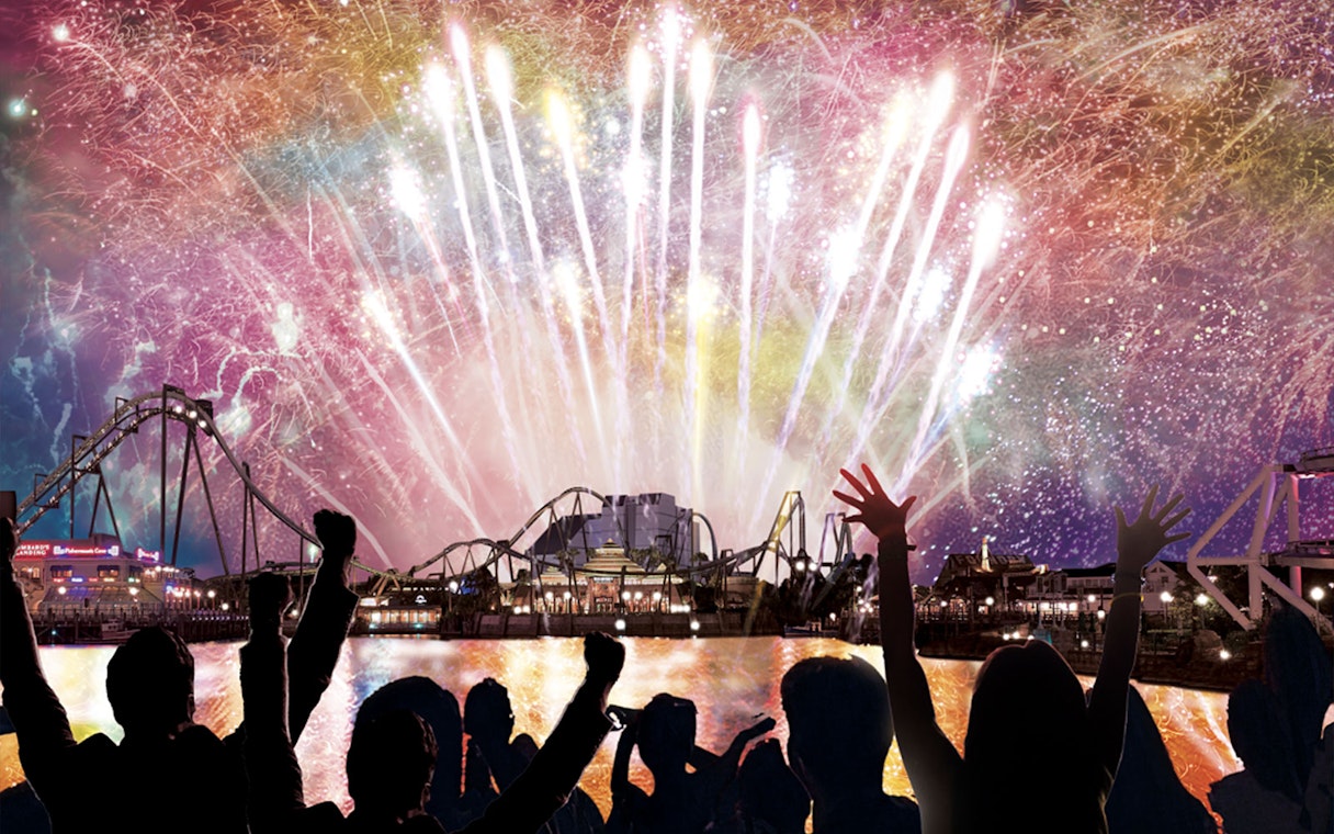 Fireworks over Universal Studios Japan during NO LIMIT! Countdown 2023 with crowd celebrating.