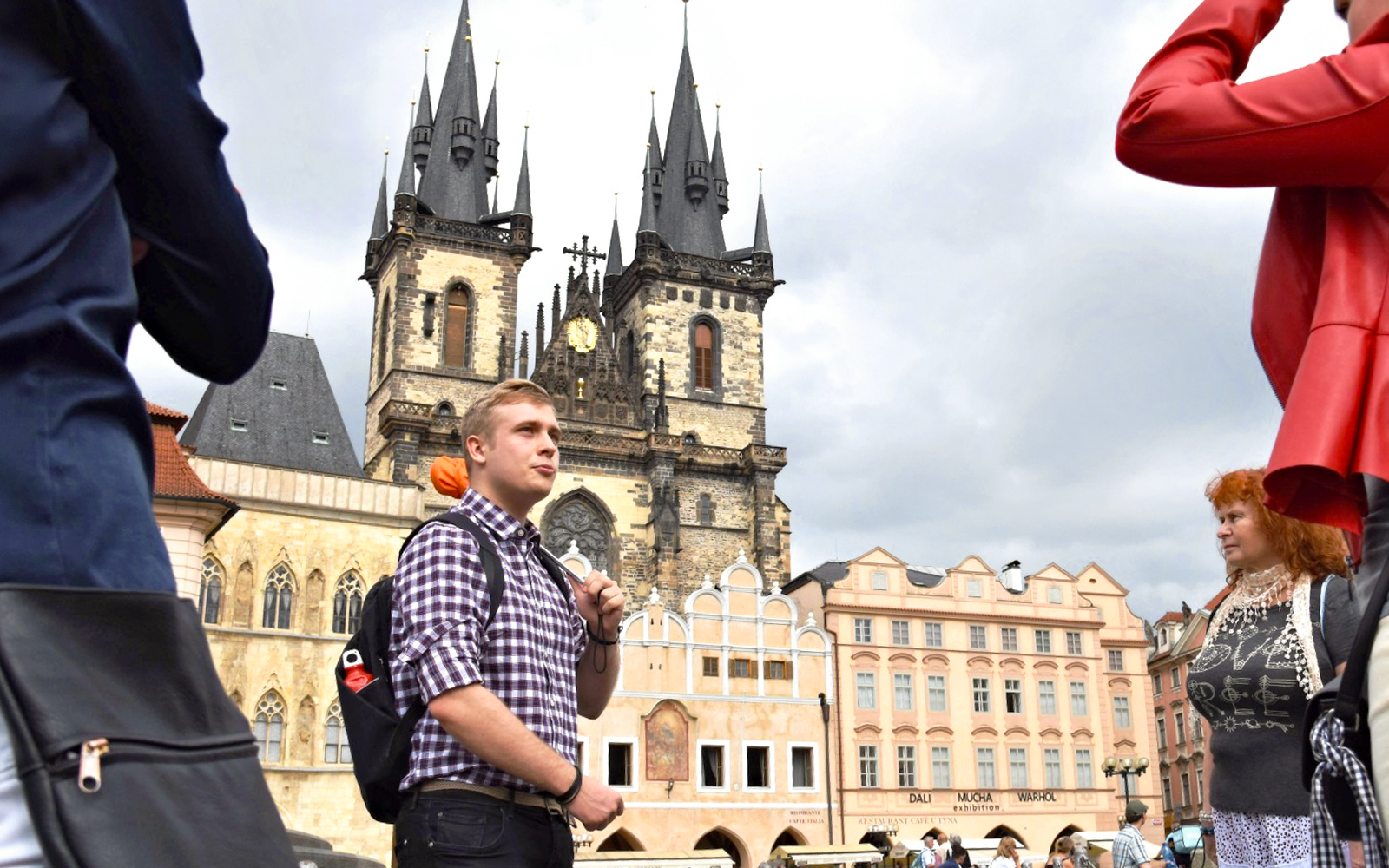 Tour guide leading a group in front of Prague's Church of Our Lady before Týn.