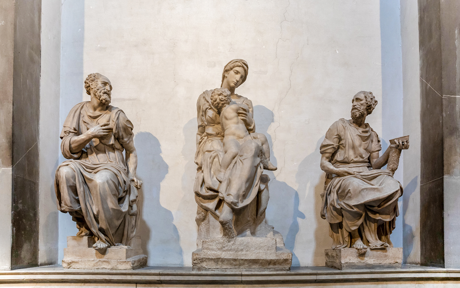 Marble sculptures by Italian artist in Medici Chapels, Florence, depicting seated figures.