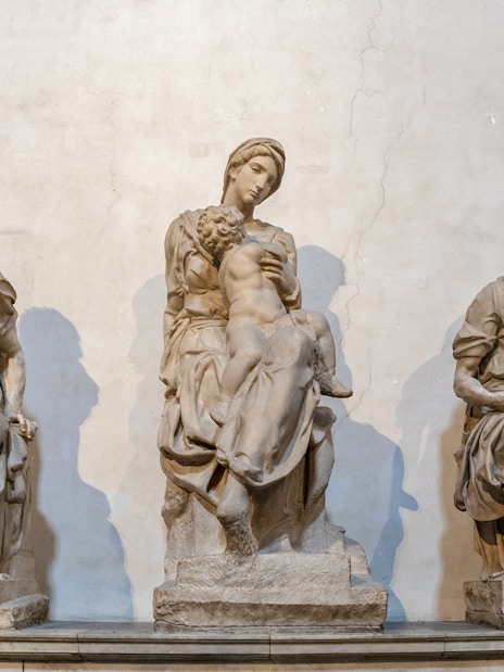 Marble sculptures by Italian artist in Medici Chapels, Florence, depicting seated figures.