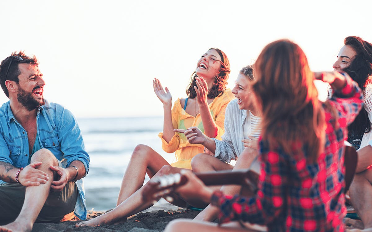 Group of friends enjoying a sunny day at Copacabana Beach, Rio de Janeiro.