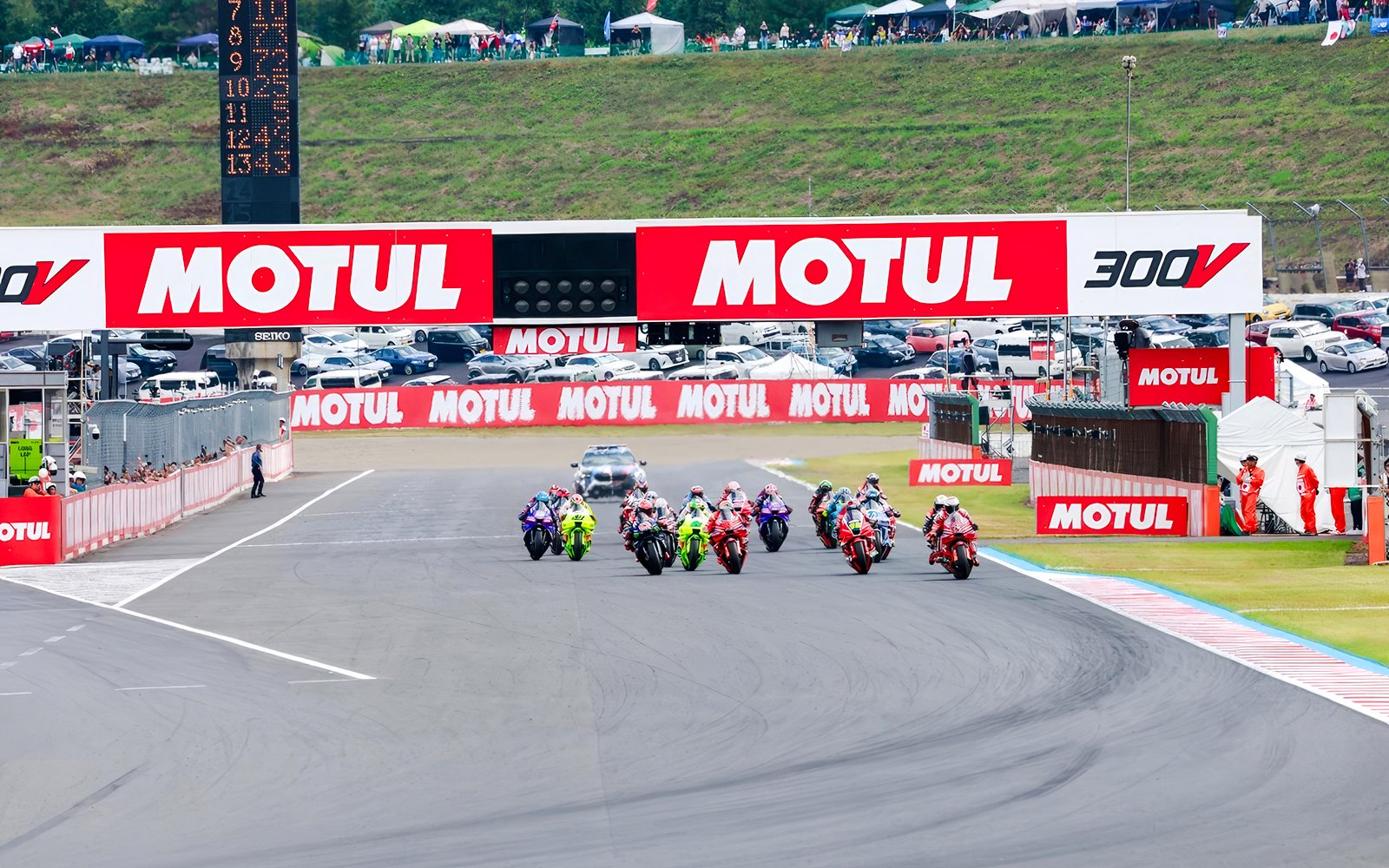Motorcycles racing at the Motul Grand Prix of Japan 2026, with spectators in the background.