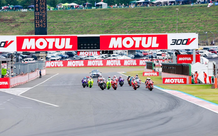 Motorcycles racing at the Motul Grand Prix of Japan 2026, with spectators in the background.