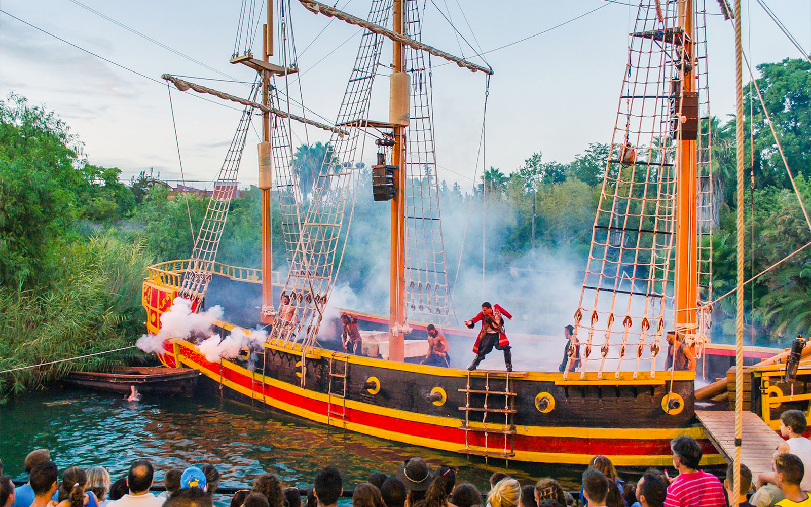 Pirate ship performance at Isla Magica with actors in costume and audience watching.