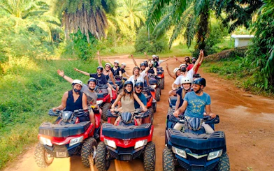 Group enjoying ATV ride through lush forest trail in Krabi.