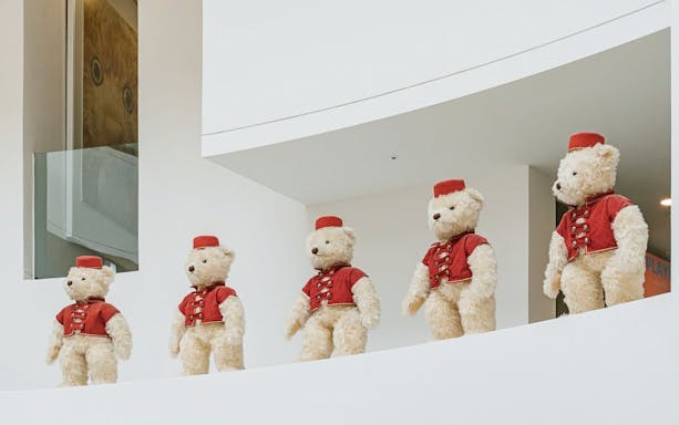 Teddy bears in red uniforms on display at Teddy Bear Museum.