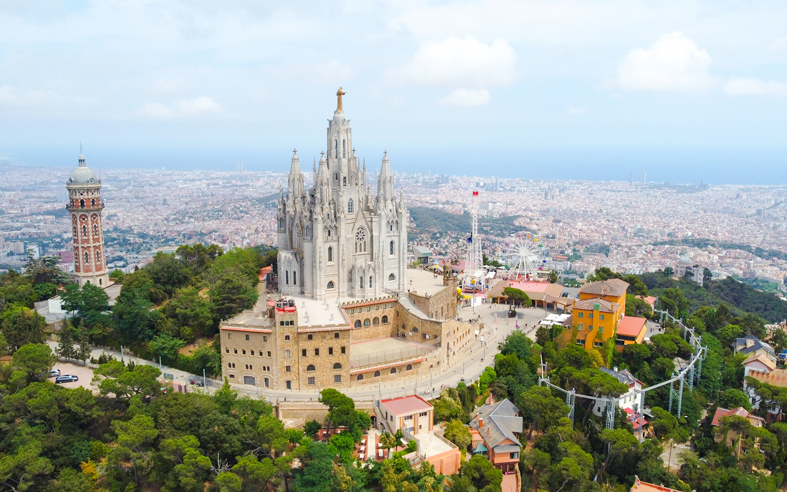 Temple of the Sacred Heart of Jesus on Tibidabo Hill, Barcelona, with cityscape in the background.