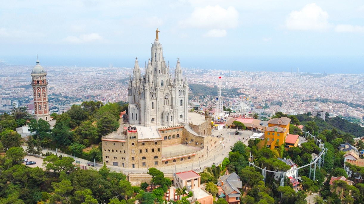 Temple of the Sacred Heart of Jesus on Tibidabo Hill, Barcelona, with cityscape in the background.