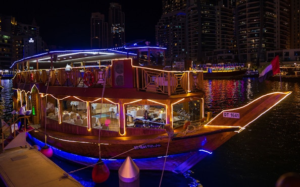 Dhow cruise with lights at night in Dubai Marina.