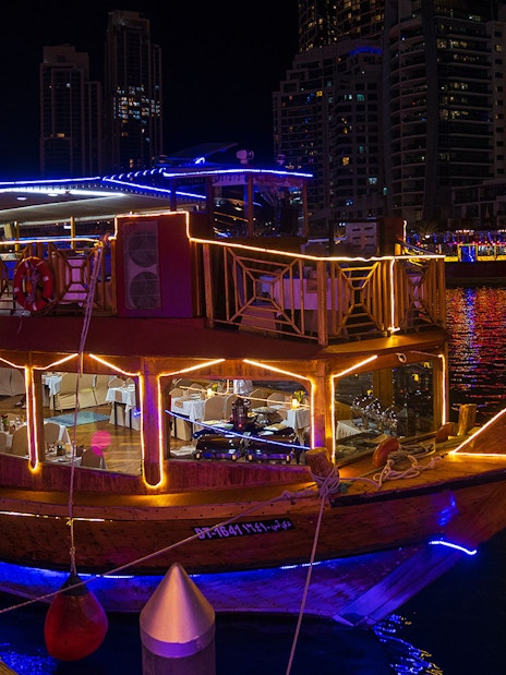 Dhow cruise with lights at night in Dubai Marina.