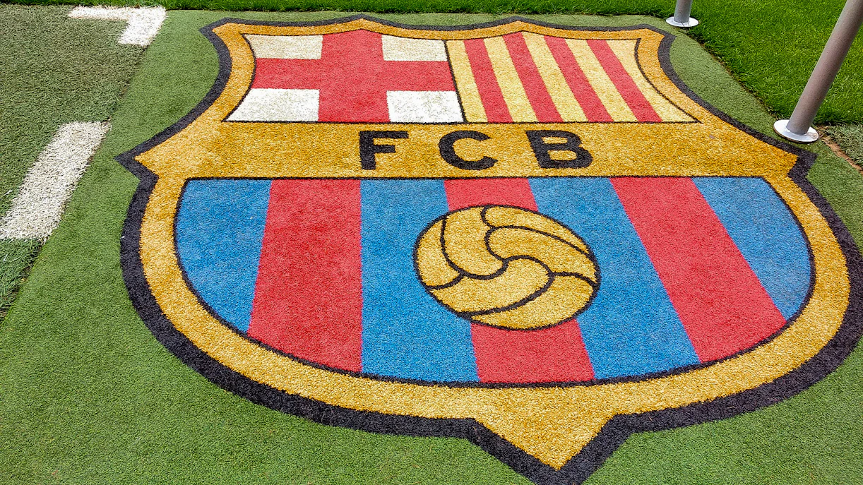 FC Barcelona Camp Nou stadium exterior with visitors exploring the entrance area.