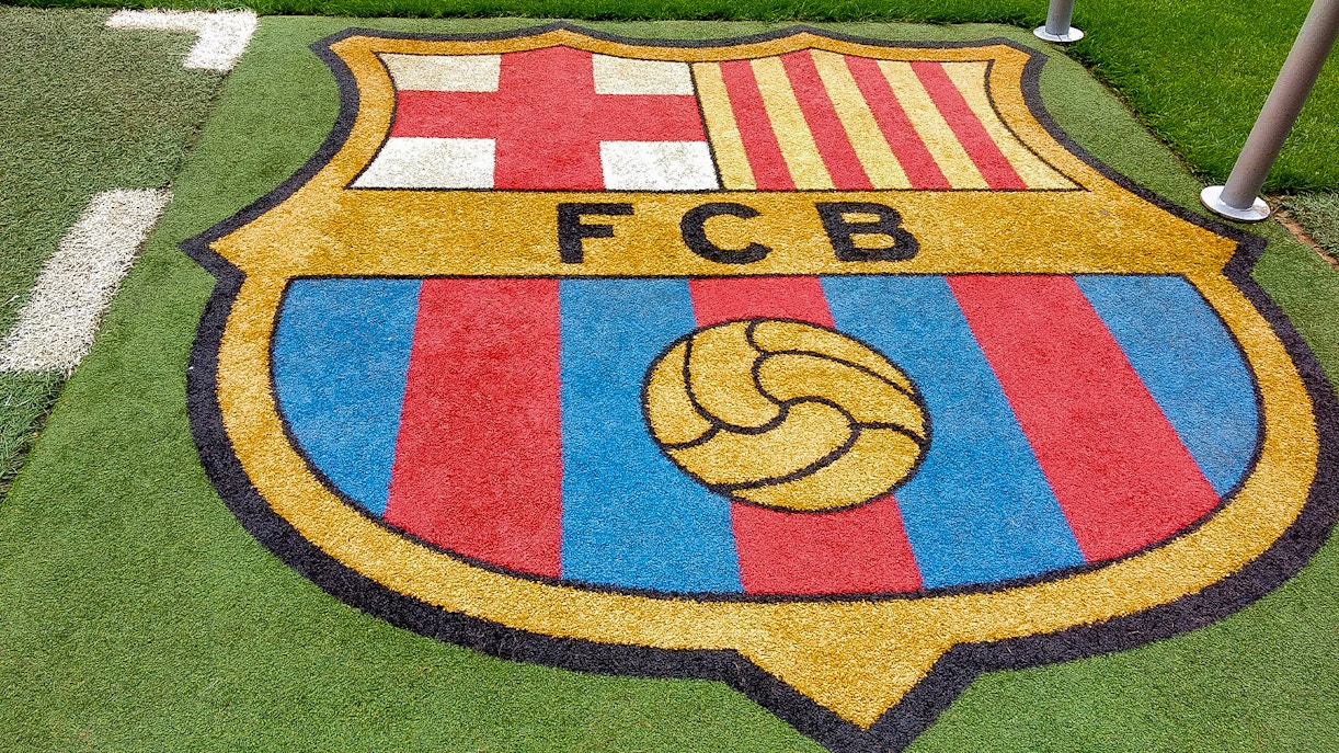 FC Barcelona Camp Nou stadium exterior with visitors exploring the entrance area.