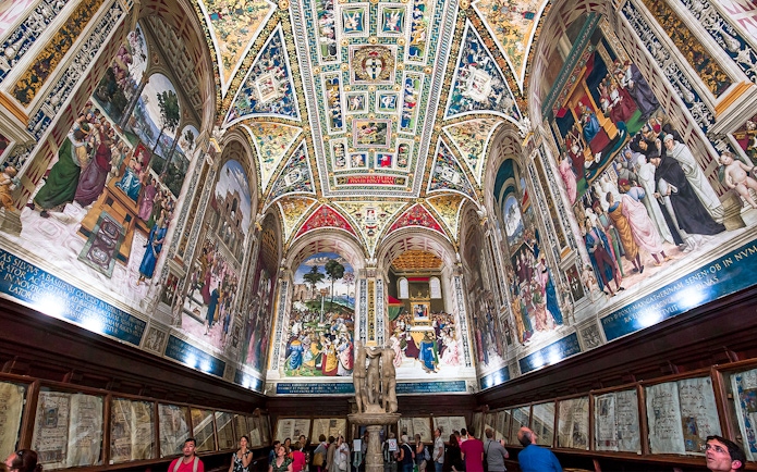 Frescoes and ornate ceiling in Piccolomini Library, Siena Cathedral, Italy.
