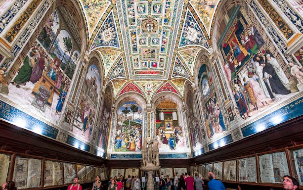 Frescoes and ornate ceiling in Piccolomini Library, Siena Cathedral, Italy.