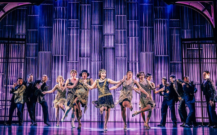 Stage performance of The Great Gatsby in New York with dancers in 1920s attire.