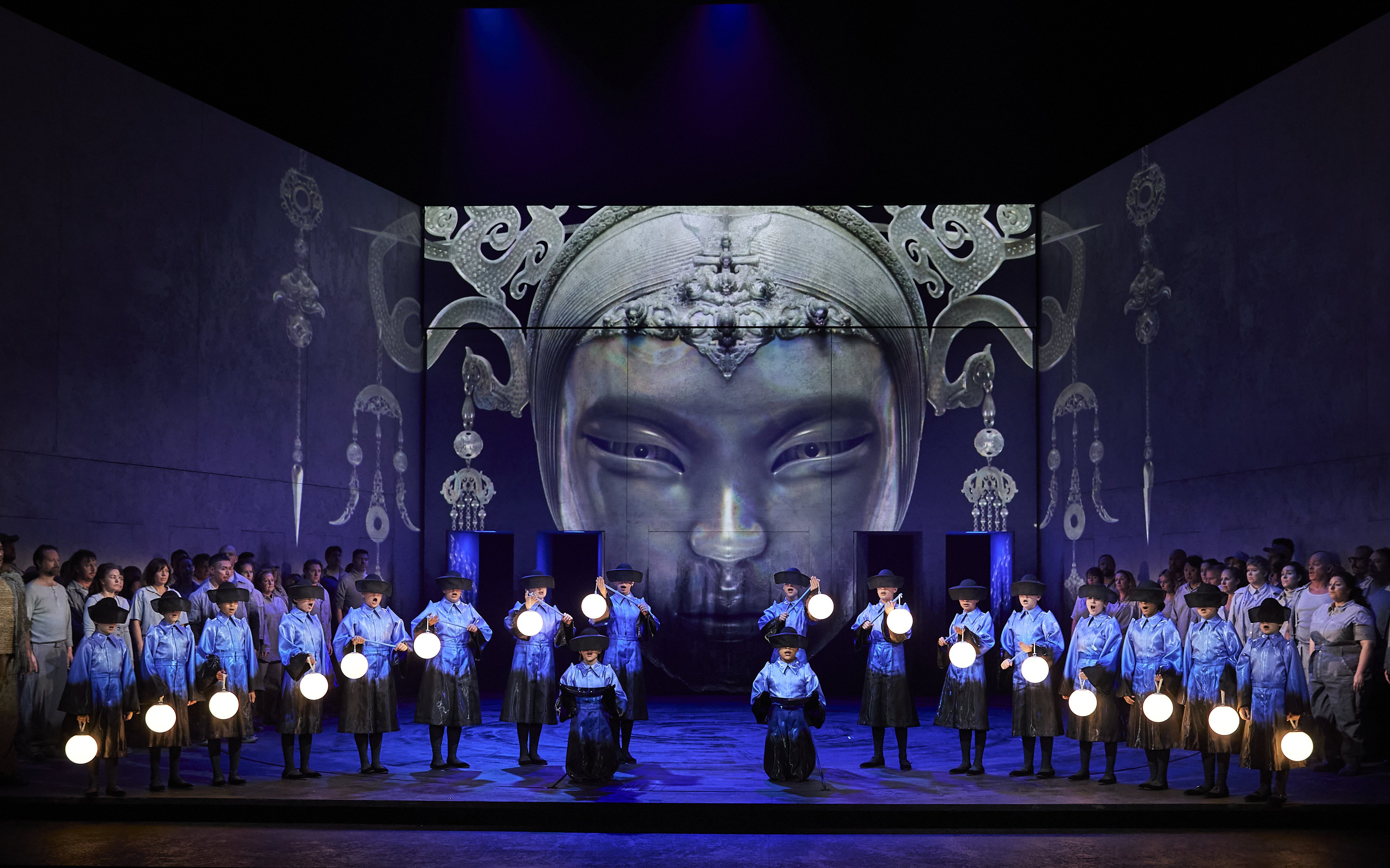Stage performance of Turandot in Sydney with performers holding lanterns.