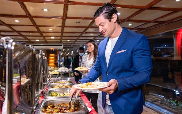 Guests serving themselves from a buffet on the Luxury Dhow Cruise.