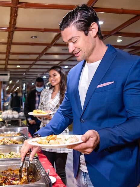 Guests serving themselves from a buffet on the Luxury Dhow Cruise.