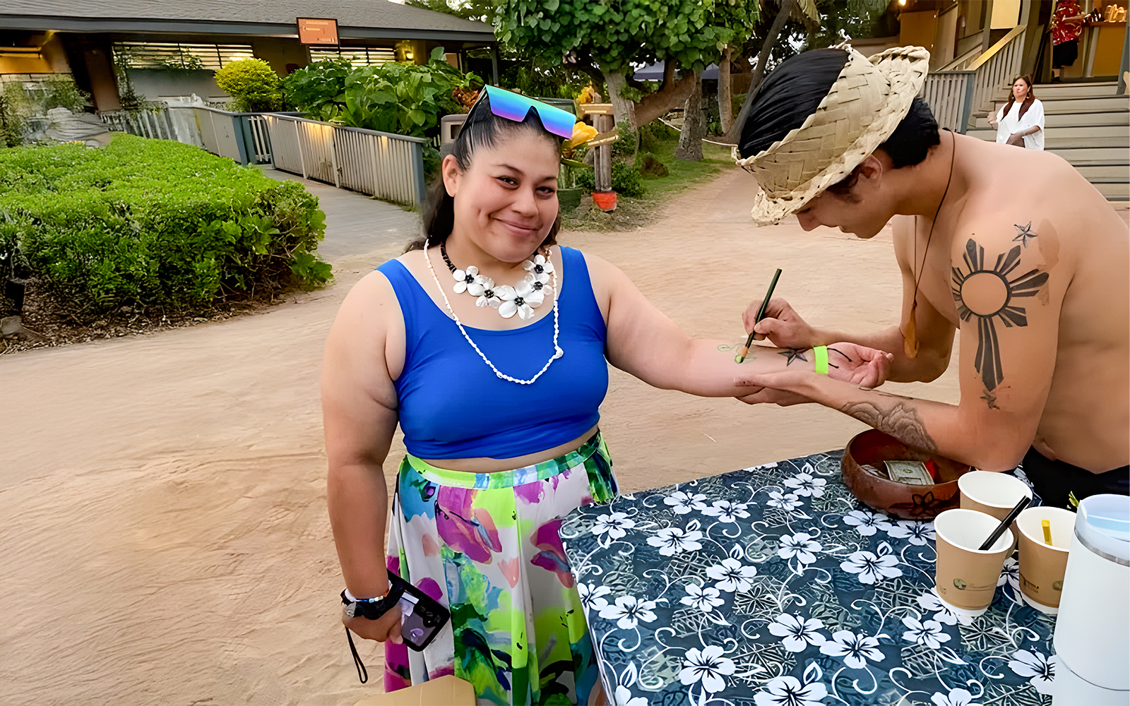 Guest receiving temporary tattoo at Germaine's Luau pre-show cultural activities.