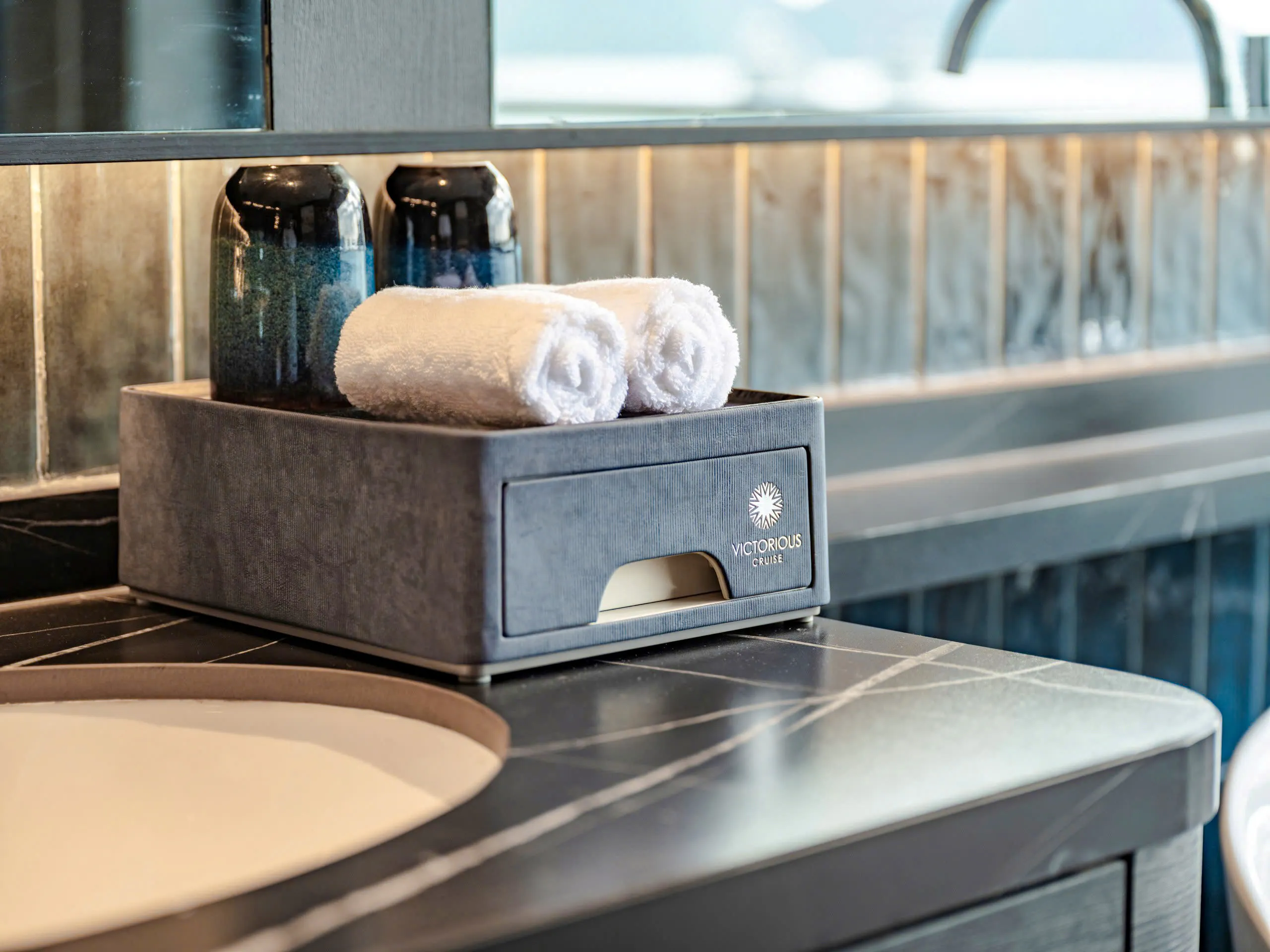 Luxury amenities on a Halong Bay cruise, featuring towels and toiletries.