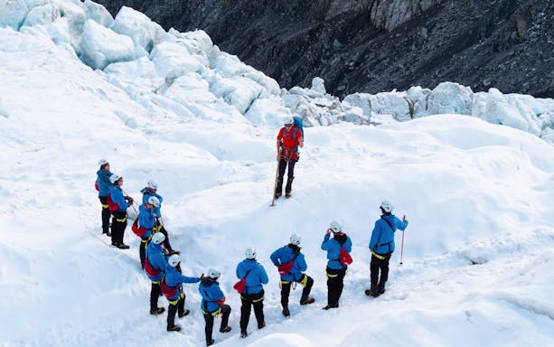 Group of hikers with a guide on a glacier trek.