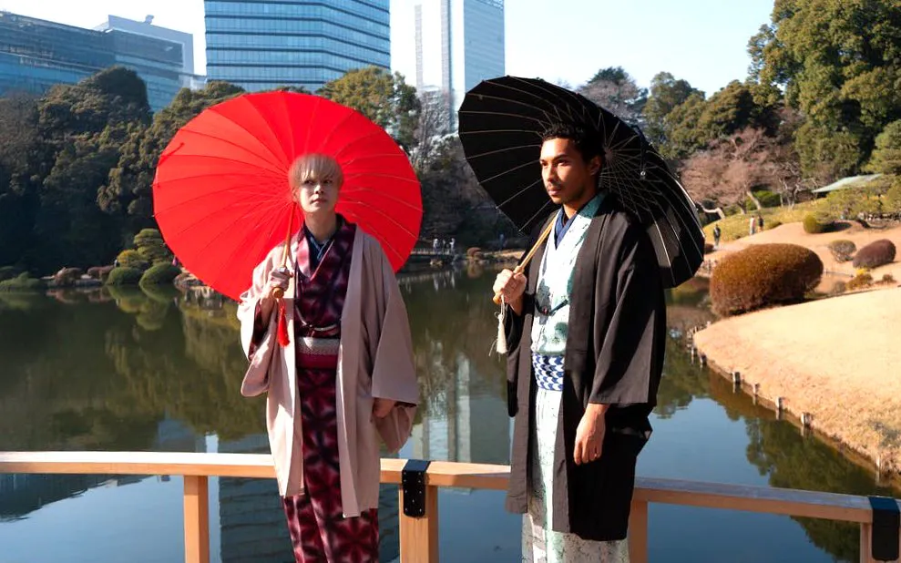 People in kimonos with umbrellas at Shinjuku Gyoen National Garden, Tokyo.
