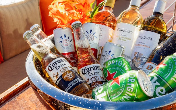 Assorted drinks in an ice bucket for Amsterdam King's Day Party Cruise with open bar.
