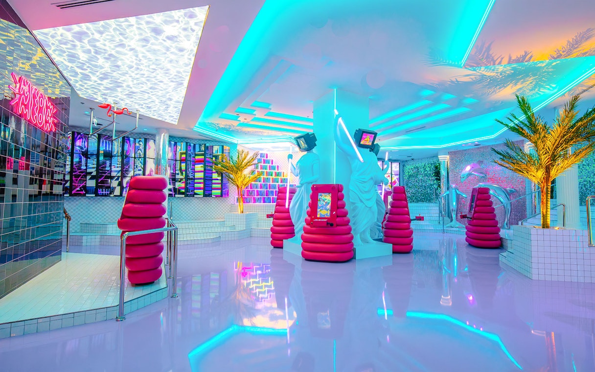 Neon-lit interior of House of Hype, Dubai with modern art installations.