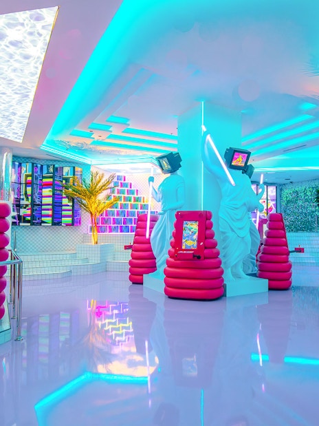 Neon-lit interior of House of Hype, Dubai with modern art installations.